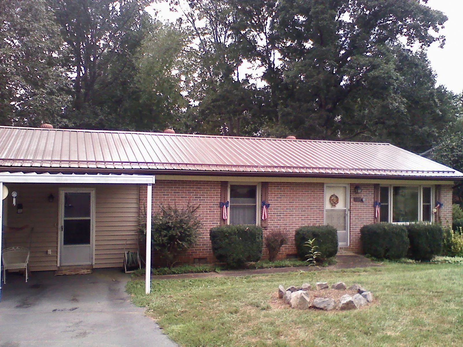 Bronze metal roof and carport on a brick ranch home — Roof Repair work by our crew in Eastchester