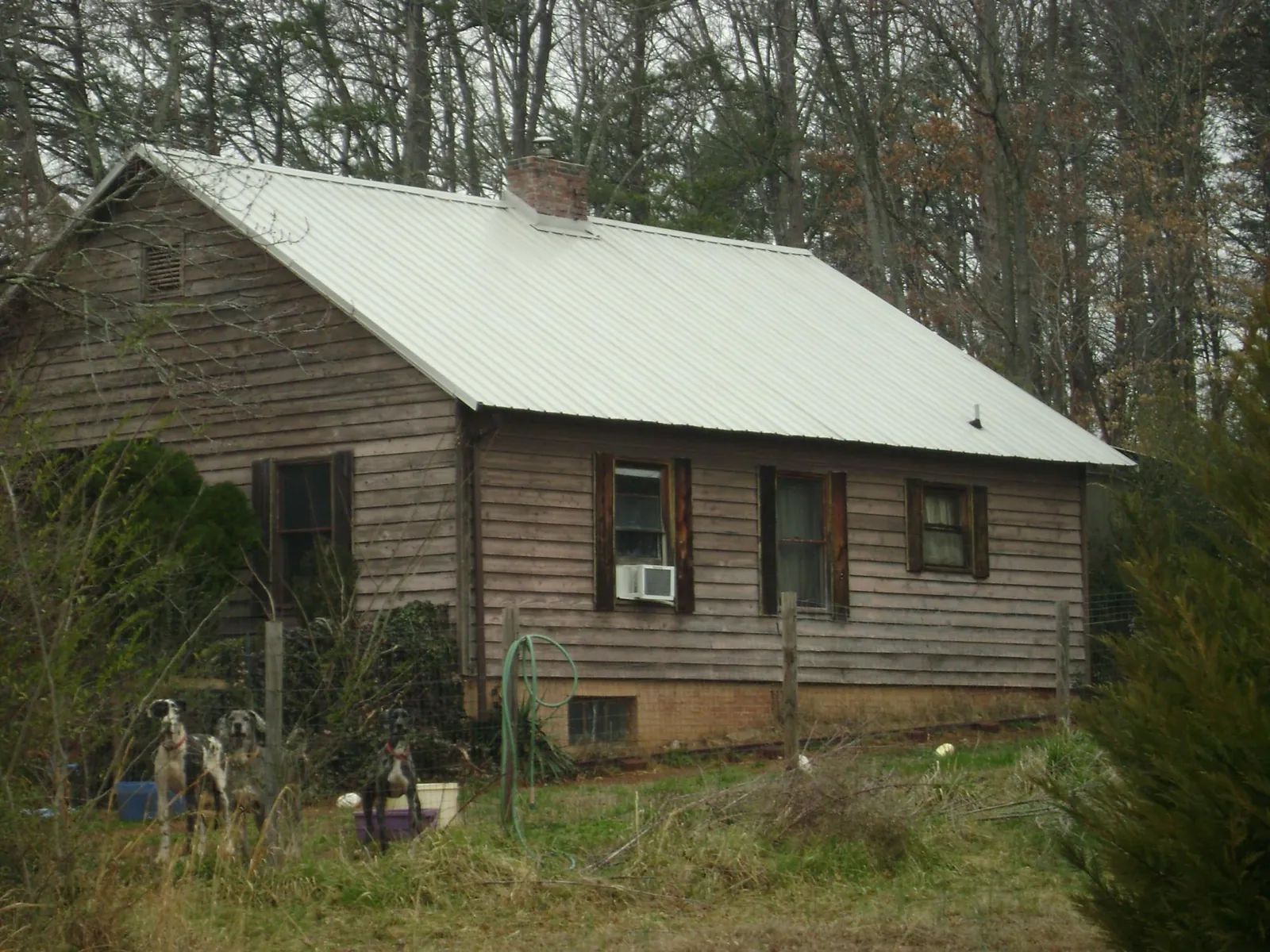 White metal roof on an old wood sided farmhouse, from a Metal Roof Installation job in Eastchester